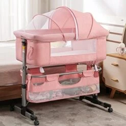 Cuddor Bedside Bassinet For Baby, Bedside Sleeper With Wheels, Heigt Adjustable, With Mosquito Nets, Large Storage Bag, For Infant/Baby/Newborn - Pink -Delta Children Shop 51NvDgZ1BUL. AC